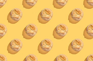 Pattern of buns on yellow pastel background