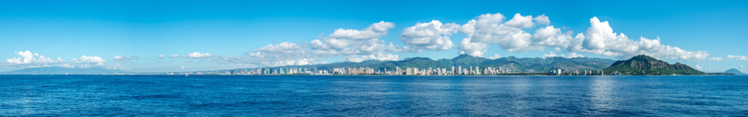 Panoramic view of of the ocean, shoreline and hills on a shiny day in Honolulu, Hawaii