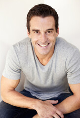 Obraz premium Hes casually and happy. Portrait of a handsome young man dressed casually and looking relaxed.