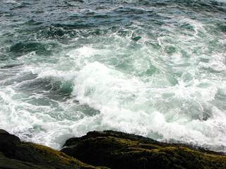crashing waves on rock coastline