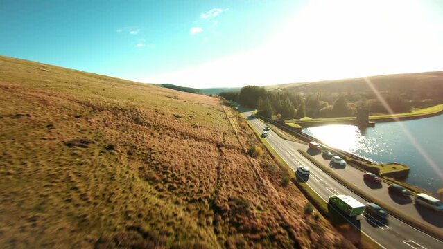 Aerial drone shot of Brecon Beacons with reservoir at the botom next to pen y fan peak. Drone video of fast flowing fpv view wales uk