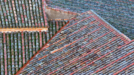 Closeup of old dirty clay roof tiles in the daylight