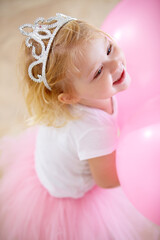 Obraz na płótnie Canvas Shes the birthday princess. A little girl dressed up like a princess at her birthday party.
