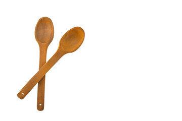 Two crossed wooden spoons isolated over white