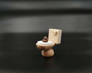 Closeup of a wooden toilet figurine