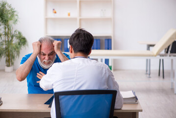 Old neck injured male patient visiting young male doctor