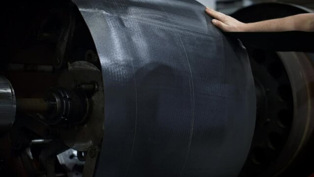 Rubber Tyre Factory Worker Setting Tape On Manufacturing Machine At Warehouse