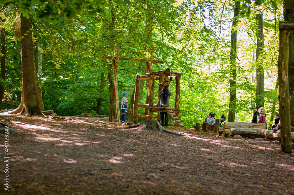 Wall mural kids playing at forest playground in sweden