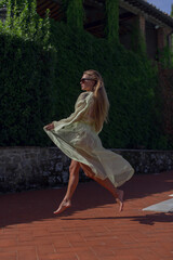 Fototapeta premium Young beautiful girl in a bright light cape