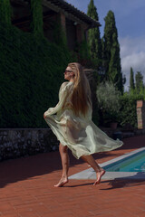 Fototapeta premium Young beautiful girl in a bright light cape