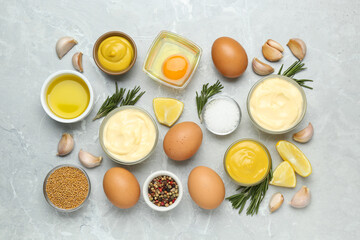 Delicious homemade mayonnaise, spices and ingredients on grey table, flat lay