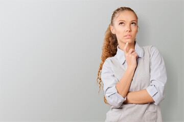 Photo of serious young woman to concentrate considers something contemplates about important thing.