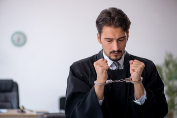 Young male judge in corruption concept