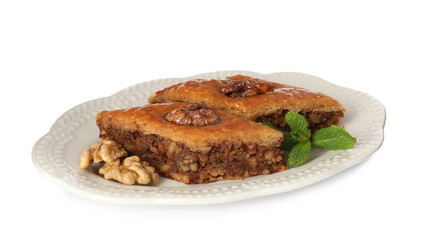 Plate of delicious honey baklava with walnuts on white background