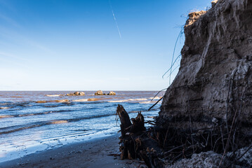 Cape Kolka with stones in water, dune and Baltic sea, Kolka, Latvia.