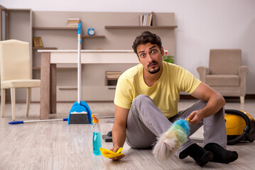 Young man doing housework at home