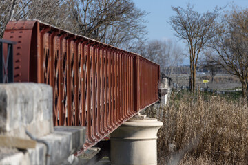 Selective focus shot of the side rails of a bridge over a river
