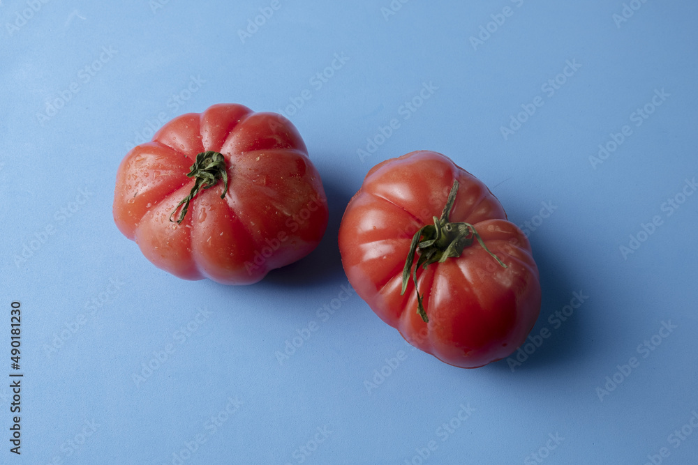 Wall mural top view of ripe tomatoes isolated on blue background