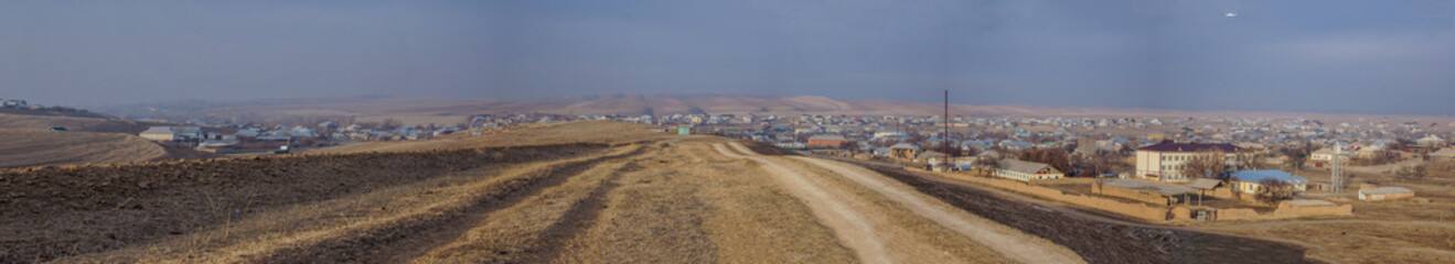 A well-trodden road near the village. Panoramic view of the village.