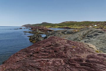 Beautiful view of Red shale rock in a sea in Newfoundland and Labrador coastline, Canada