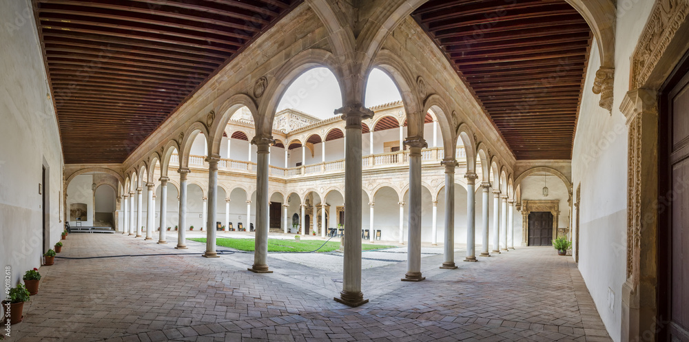 Poster panoramic view of a paved and illuminated walkway with columns
