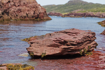 Beautiful view of Red shale rock in a sea in Newfoundland and Labrador coastline, Canada