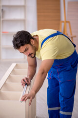 Young male carpenter working at home