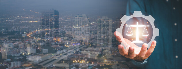Justice and law concept, Male lawyer hand holding holographic law icon with city scape background,...