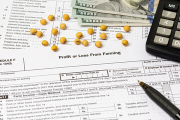 Soybeans and farm tax form. Farming income, finances and management concept.