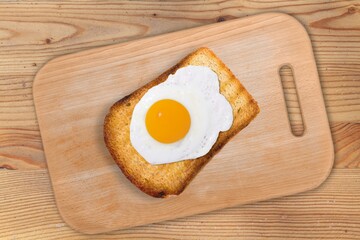 Breakfast with fried egg and toasted bread. Valentines day food