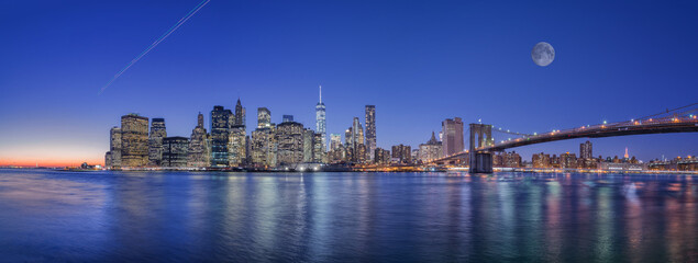 Mesmerizing view of Manhattan with lights reflections in the water under moon sky, New York City