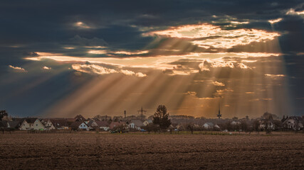 Village with a filed at scenic sunset
