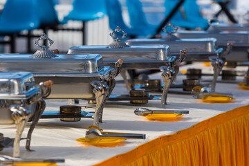Chafing dish containers in a raw ready for upcoming guests to the buffet restaurant