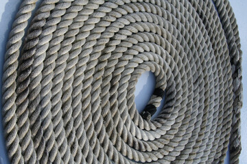Closeup of a rope coil on a white metallic surface