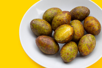 Hog plum on yellow background