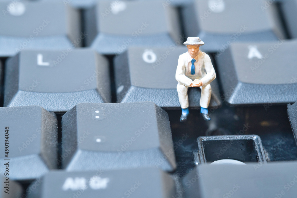 Poster miniature you sit on a computer keyboard