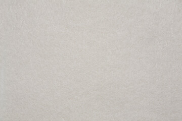 Fototapeta na wymiar Horizontal beige felt material texture background. Close up.
