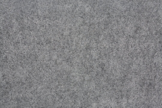 Horizontal dark grey felt material texture background. Close up.