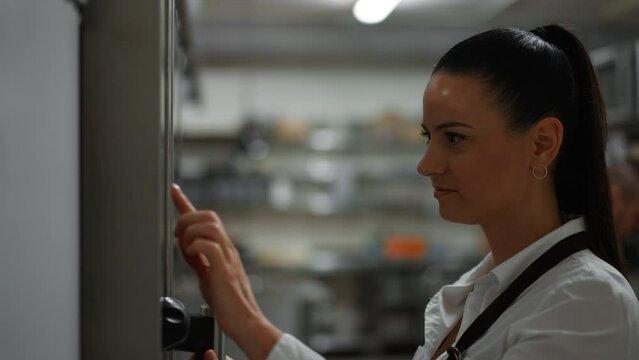 Chef using combi oven in restaurant kitchen.
