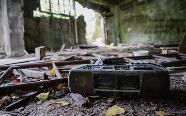 retro broken and outdated portable stereo left in abandoned building