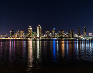 Beautiful night colorful scene of the san diego skyline reflecting in the water, CA, USA - obrazy, fototapety, plakaty