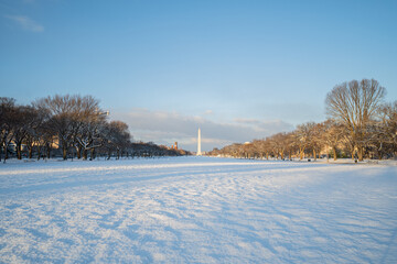 National Mall and the Washington Monument covered in snow during sunrise right after a snowstorm