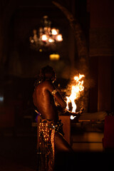Back shot of a performer Moroccan fire breather, in Marrakech at night