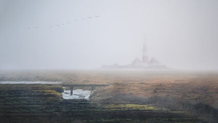 Westerheversand Lighthouse in a moody fog in Westerhever, Germany