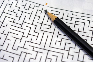 maze puzzle game and pencil to solve