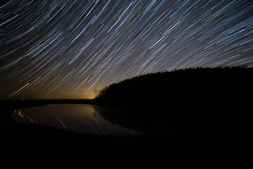Star trails above a lake