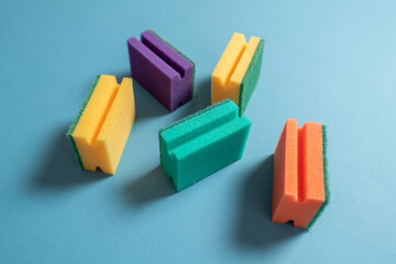 five cleaning sponges of different color flat lay, household concept