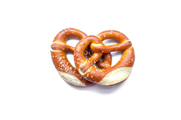 two freshly baked pretzels close-up, isolated on a white background