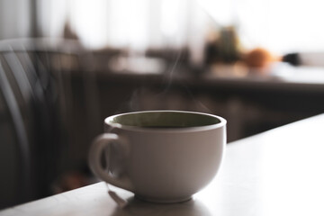 cup of hot drink on the table with aromatic steam