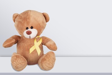 International Childhood Cancer Awareness month, Children toy with golden Ribbon for supporting